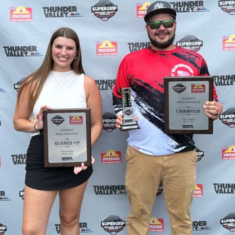 NHRA Celebrity Drag Race Challenge winner Sean Embree (right) poses with his trophy and plaque, while Lauren Bradford of WCYB TV 5 Sports holds her runner-up prize. 