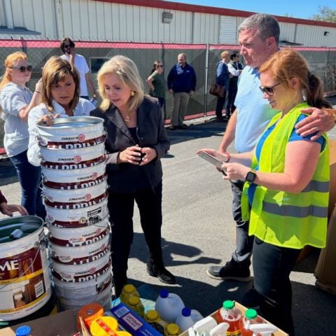 Diana Harshbarger (left) and Marsha Blackburn (center) are given a tour of a donation unloading area by BMS president and general manager Jerry Caldwell (right) and track employee Lyndsay Skinner.