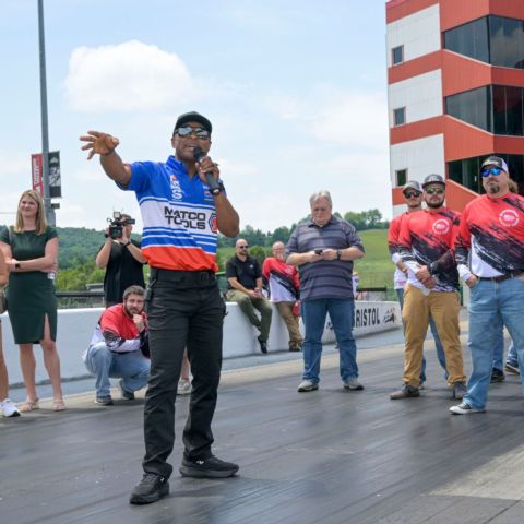 NHRA Top Fuel champ Antron Brown gives the celebrity participants a quick Drag Racing 101 before their practice round.